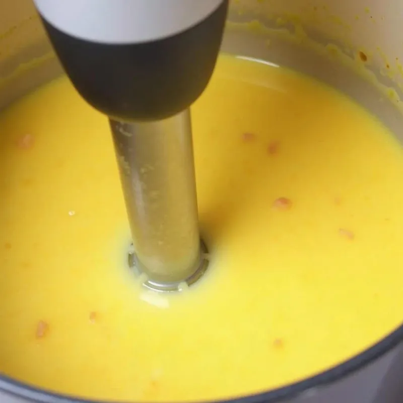 Blending vegan potato soup using an immersion blender