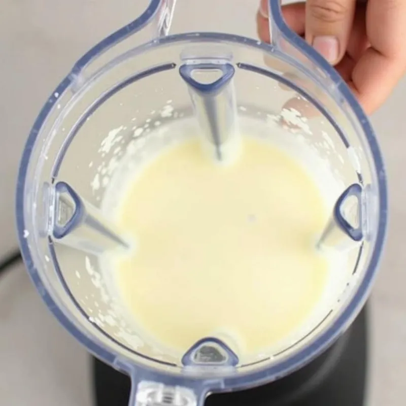 High-speed blender filled with vegan ricotta ingredients.