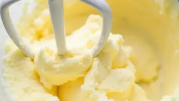 Creaming vegan butter and sugar in a bowl