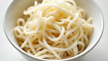 Dried wide rice noodles in a bowl