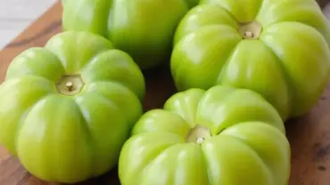 Green tomatoes on a cutting board