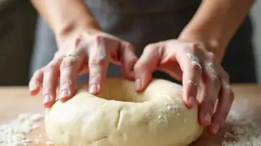 Woman kneading vegan bagel dough on a lightly floured surface