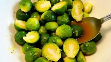 Vegan Maple Dijon Brussel Sprouts Being Tossed in a Bowl