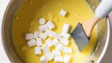 Melting vegan marshmallows in a saucepan with vegan butter.