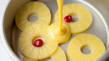 Pouring Cake Batter Over Pineapple Topping