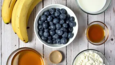 Vegan banana blueberry muffin ingredients laid out on a table