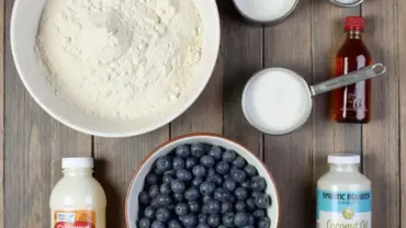 Vegan blueberry muffin ingredients laid out on a table