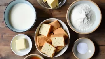 Vegan bread pudding ingredients laid out on a wooden table