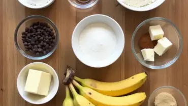 Vegan chocolate chip banana bread ingredients laid out on a table