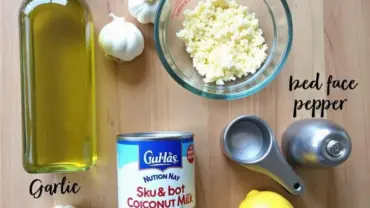 Vegan coconut milk alfredo sauce ingredients arranged on a table