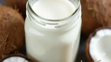 Vegan Coconut Milk in a Glass Jar with Coconuts