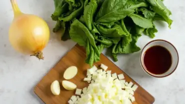 Fresh ingredients for vegan collard greens with liquid smoke.