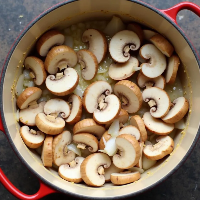 Mushrooms cooking in a pot on the stove