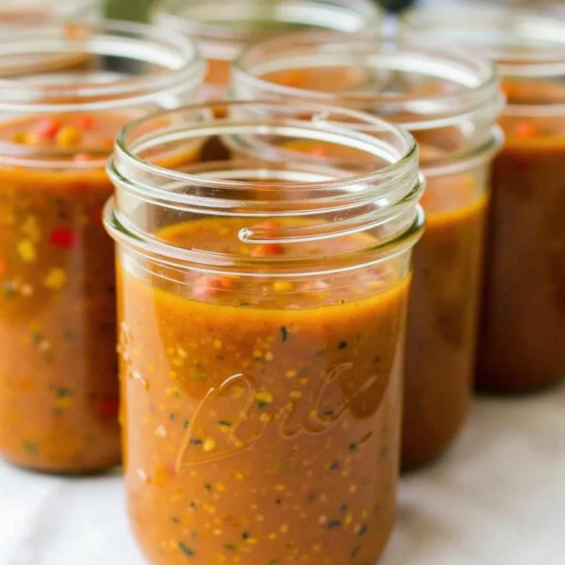 Vegan lentil soup stored in glass jars for meal prep