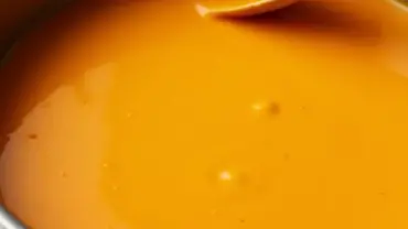 Vegan nacho cheese sauce simmering in a saucepan