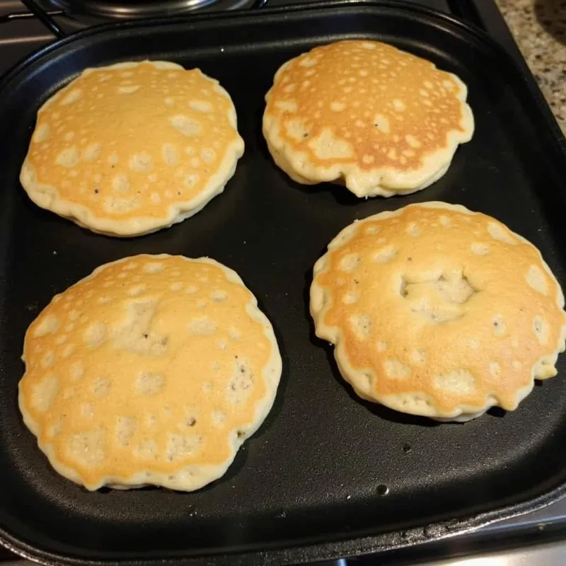  Vegan oat flour pancakes cooking on a griddle