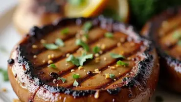 Grilled vegan portabella mushroom steaks on a white plate