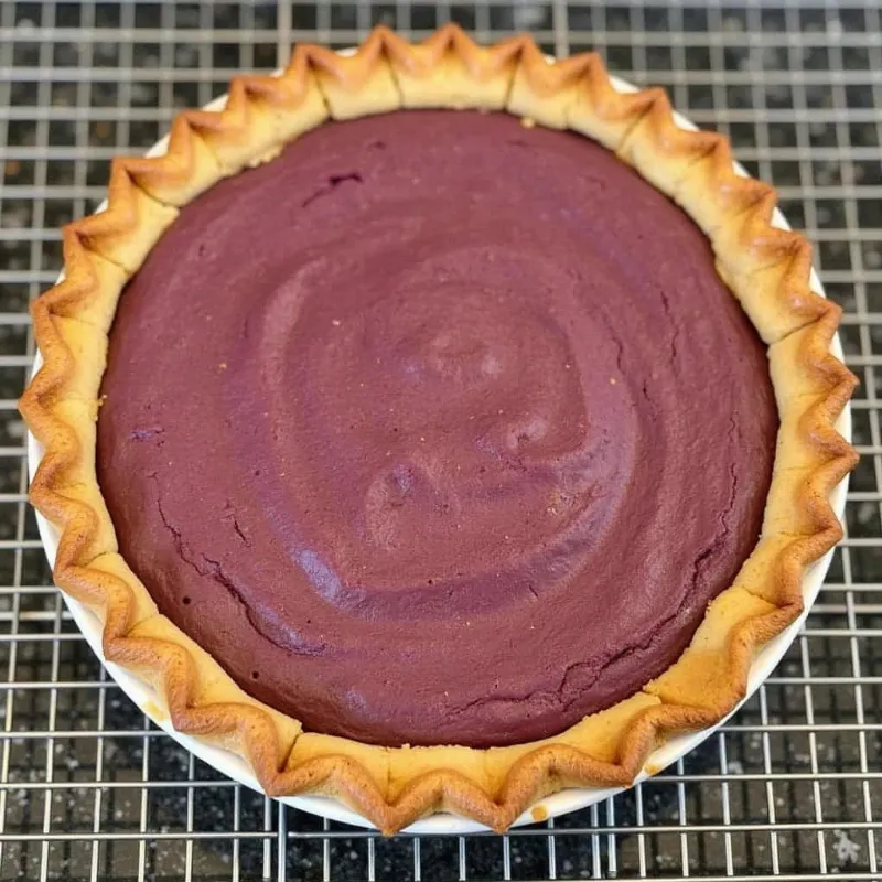 Freshly baked vegan purple sweet potato pie cooling on a wire rack