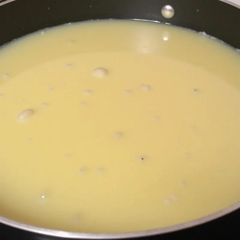 Vegan rice pudding simmering in a pot on the stove