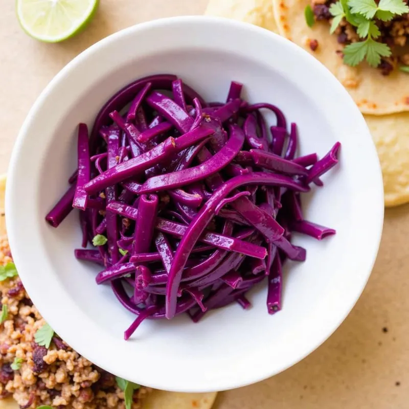 Vegan slaw in a bowl, ready to be added to tacos