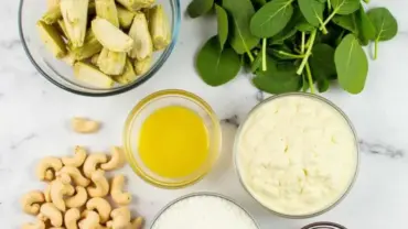 Vegan spinach artichoke dip ingredients arranged on a table