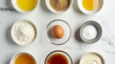 Vegan sugar cookie ingredients laid out on a marble countertop.