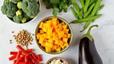 A colorful array of fresh vegetables and herbs for vegan Thai red curry